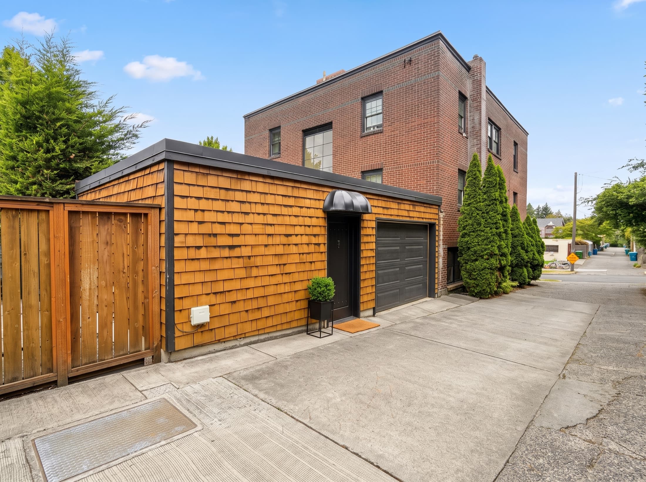 The cedar-shingle studio at the rear of East Highland Apartments